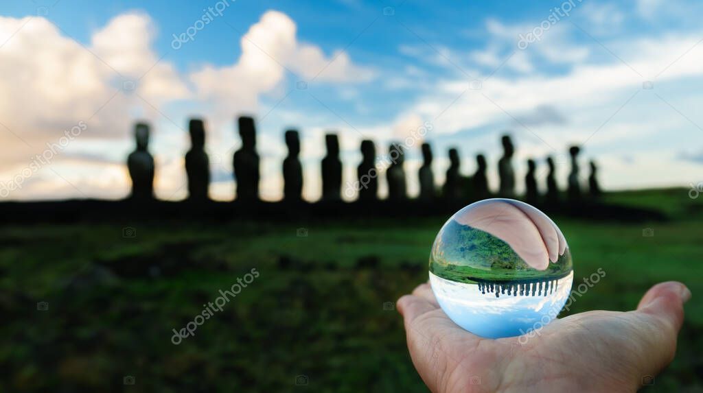 Crystal ball on focus and Ahu Tongariki at dawn on the background