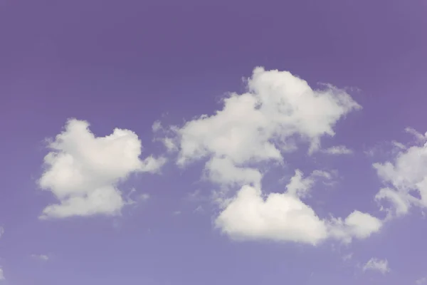 Purple sky with group of white clouds as wallpaper or background.