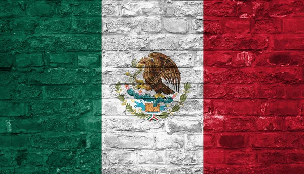Flag of Mexico over an old brick wall background, surface