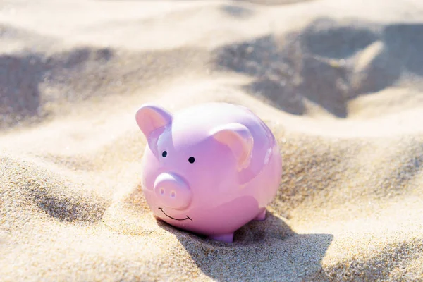 Ceramic pink pig on the sand on a Sunny day. The concept of recreation and tourism 2019.