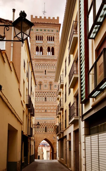 Calle Amantes street and Saint Martin\'s Tower (Torre de San Martin) - medieval structure in  Mudejar style in Teruel, Aragon, eastern Spain. Popular tourist attraction in the center of old town.