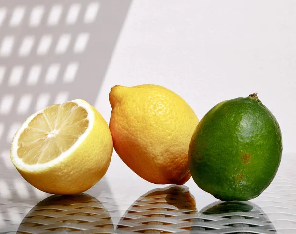 Two lemons and lime — Stock Photo, Image