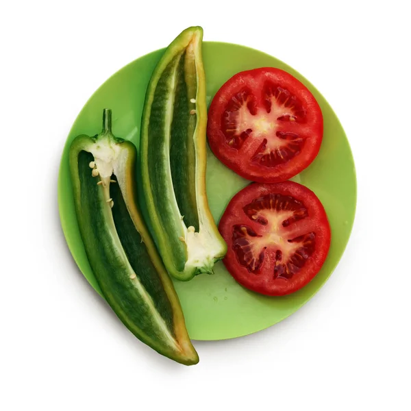 Peperoni e pomodoro sul piatto verde — Foto Stock