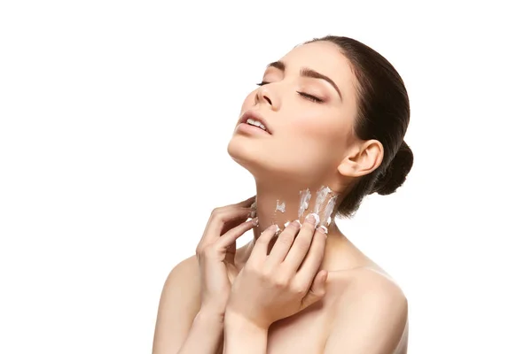 Girl applying moisturizing cream isolated on white — Stock Photo, Image