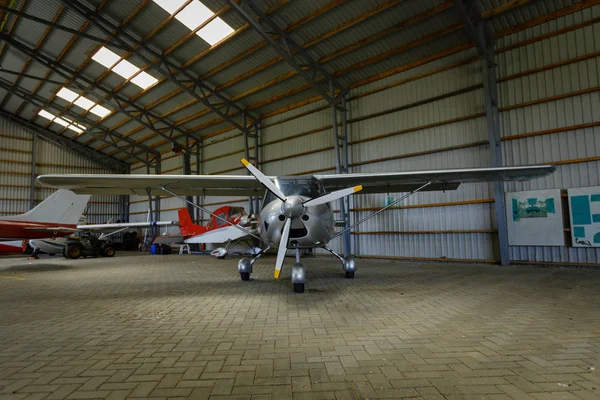 Outdoor shot of small plane standing in shed — Stock Photo, Image