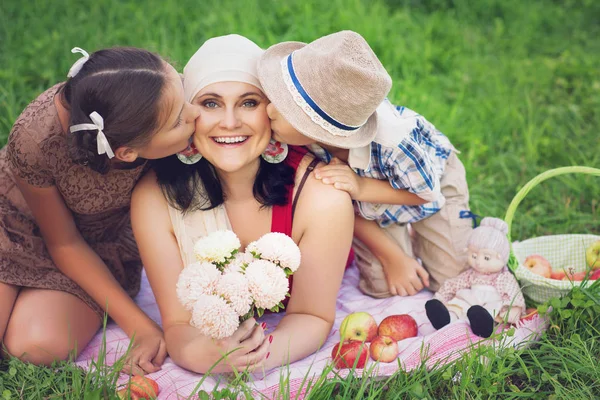 Mutter mit zwei Kindern beim Picknick im Freien — Stockfoto