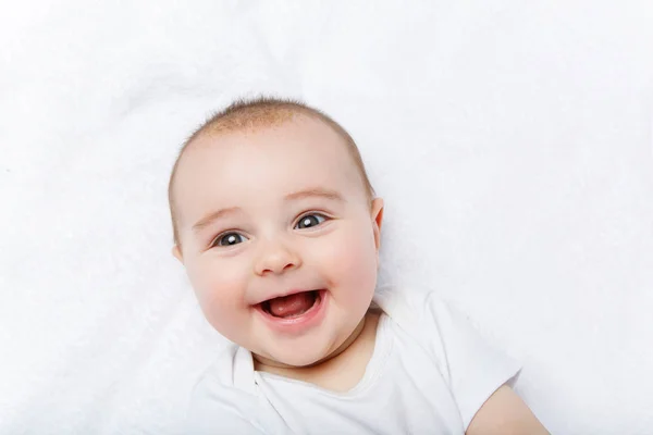 Happy beautiful baby boy in white body suit — Stock Photo, Image