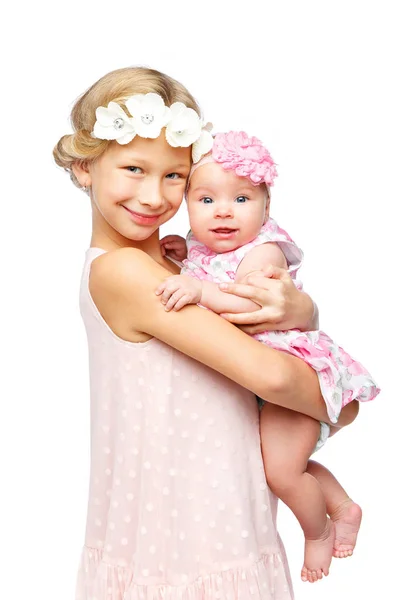 Happy beautiful girl with baby sister — стоковое фото