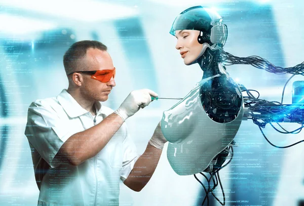 Mühendis laboratuarda dişi bir robotu tamir ediyor.