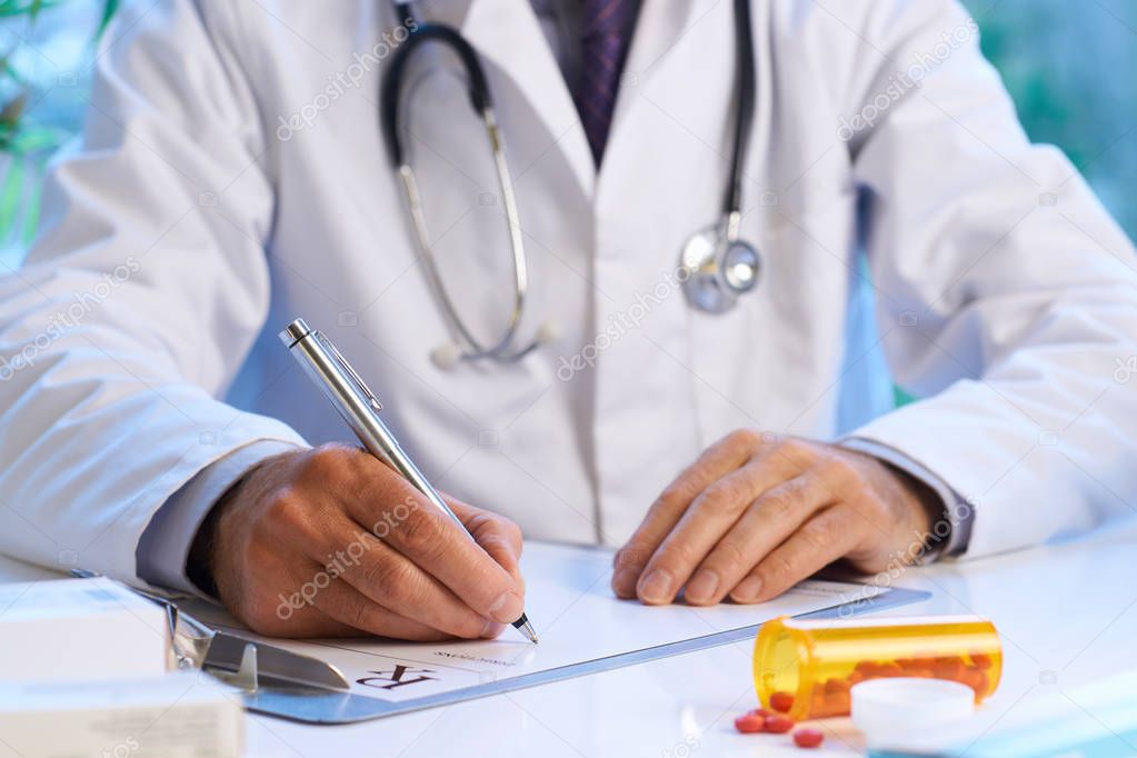 Doctor writing out RX prescription