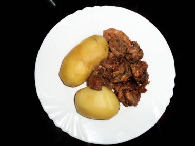 bir tabak patates ile kızarmış et parçaları