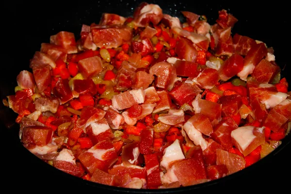 raw meat cut into small slices cooked for frying in a frying pan