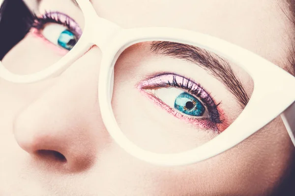 Görüntü güzel bir genç kadının gözlük takıyorum. Parlak makyaj. — Stok fotoğraf
