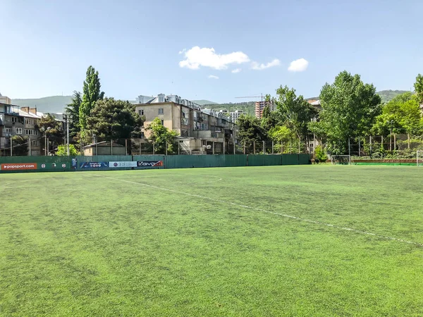 TBILISI, GEORGIA -  - MAY 17, 2018:  Football stadium between residential buildings. Springtime in city.