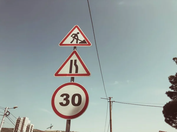 Traffic sign against the sky : "Be careful road works are being carried out." Speed: 30 km  h. — Stock Photo, Image