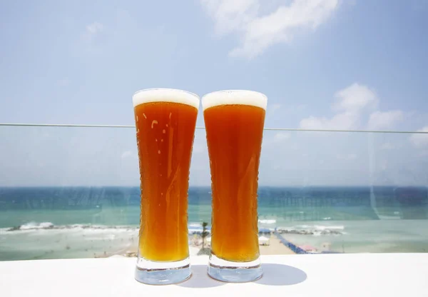 Two glasses of cold beer on sea background — Stock Photo, Image