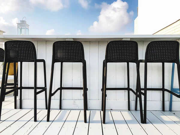 Vacant seats at the open-air bar on the roof