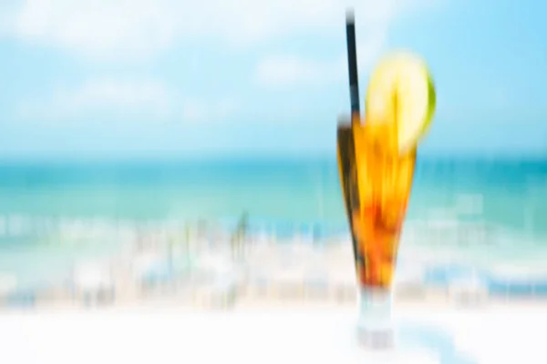 Cocktail drink on wood table on the sky background. Abstract motion blur effect background — Stock Photo, Image