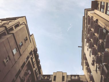 Aşağıdan gökyüzüne doğru yükselen bir binanın görüntüsü.
