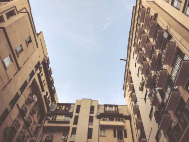 Aşağıdan gökyüzüne doğru yükselen bir binanın görüntüsü.