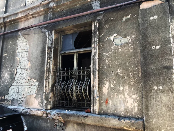 Old Tbilisi architecture, yard, windows in summer day. Old brick wall