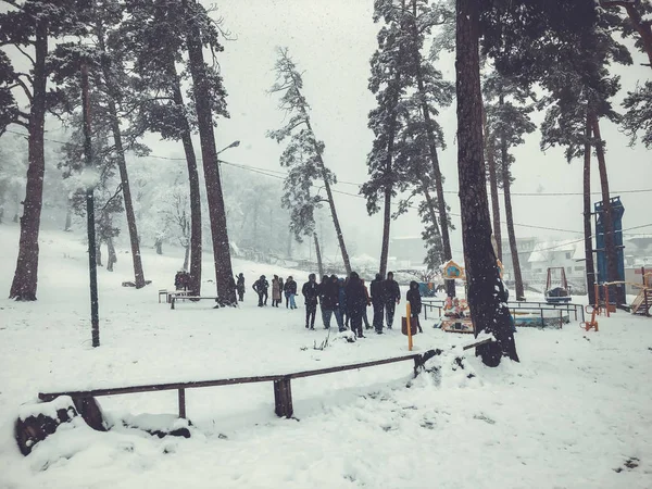 Mountain ski resort Bakuriani, Georgia. The first snow in the city. Children walk in the snow — Stock Photo, Image