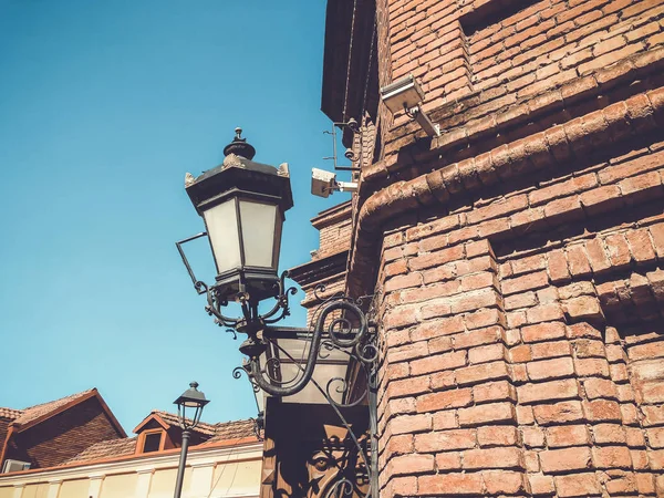 Old Tbilisi architecture. The bricks wall and  street light in summer day