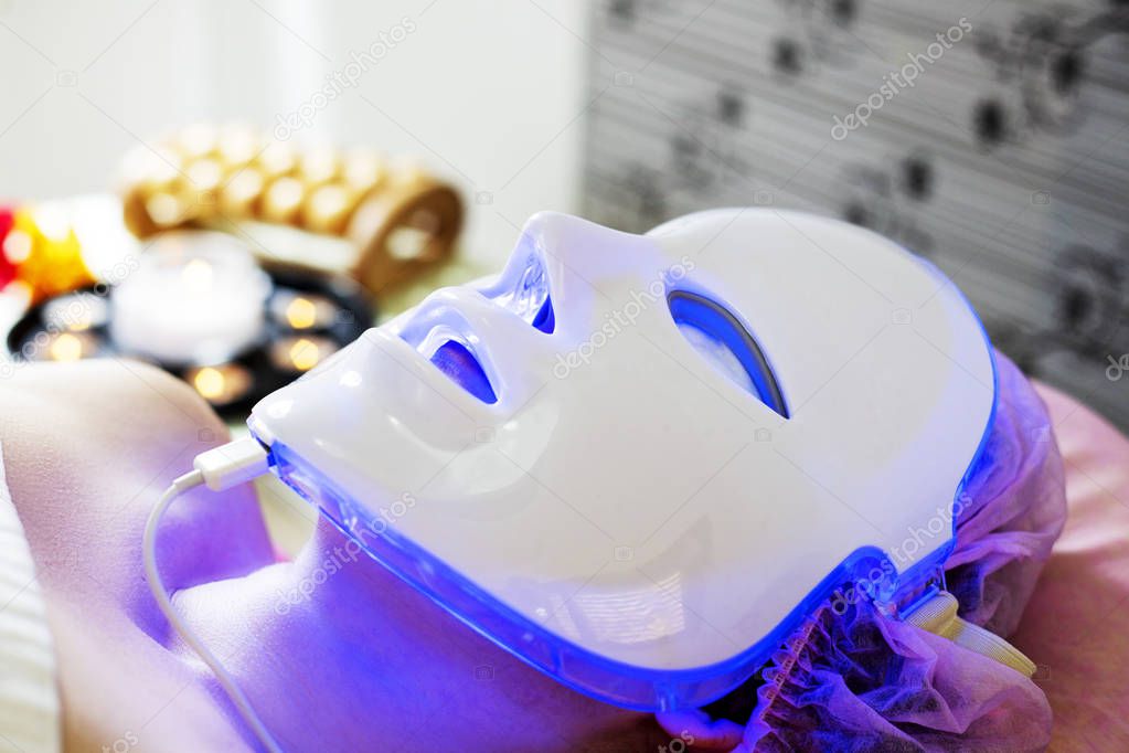 Photodynamic therapy facial mask on woman's face.