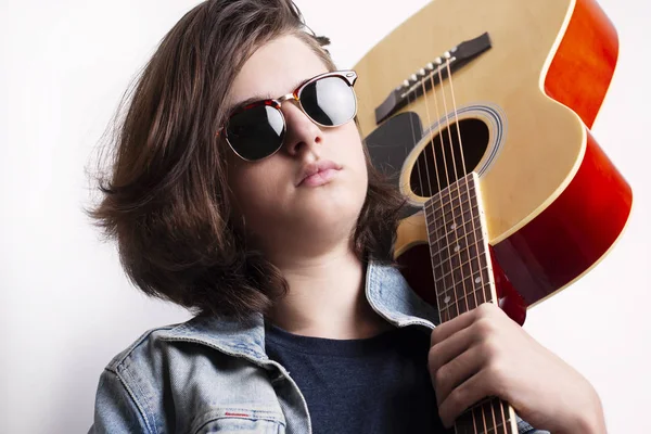 Portrait of a teenager playing guitar in studio. — Stock Photo, Image