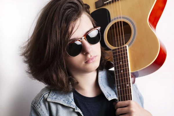Portrait of a teenager playing guitar in studio. — Stock Photo, Image