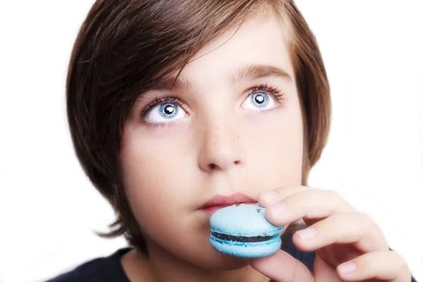 Schöner Junge hält Makkaroni vor weißem Hintergrund in den Händen. — Stockfoto