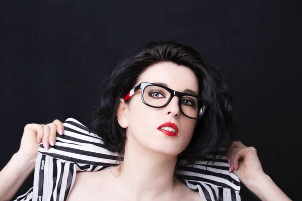 Portrait of a young attractive woman with glasses on dark background — Stock Photo, Image