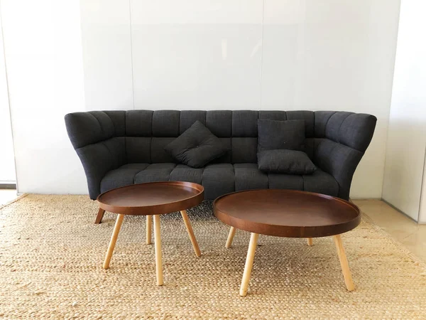 Panorama of living room with black sofa, round tables. — Stock Photo, Image