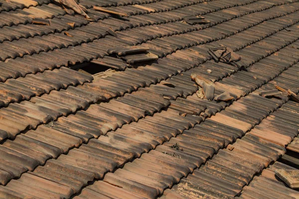 Broken old terracotta rooftiles with hole Stock Image
