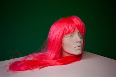 Statue in wig on green 