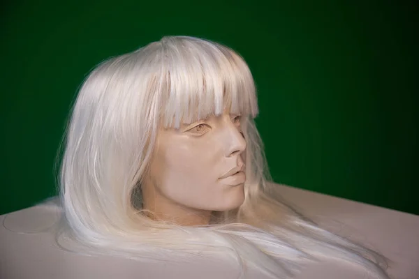 Statue in wig on green 