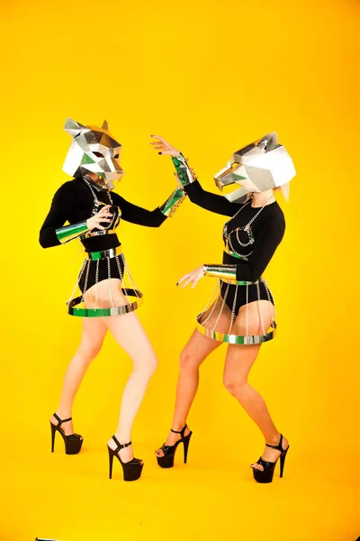 Amazing GoGo girls with metal panther heads posing in studio