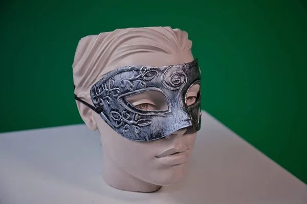 mannequin in mask   on a green  background