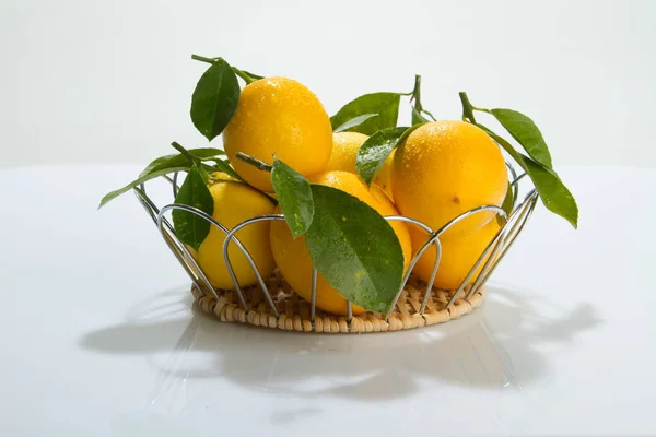 Citrus fruits, lemons on a white background with leaves.
