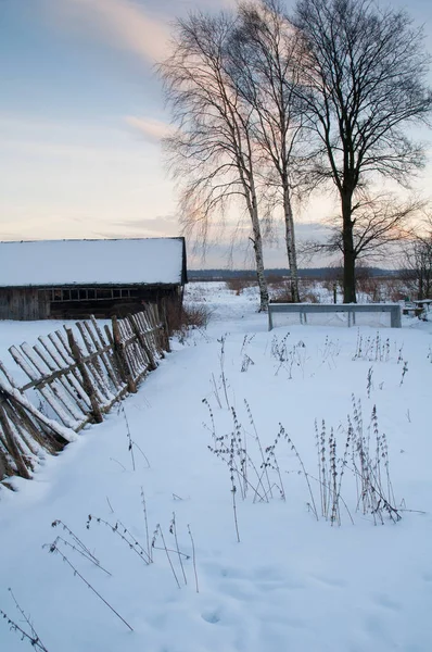 Village houses in winter in the evening in the sun.