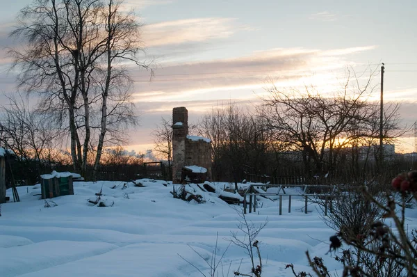 Village houses in winter in the evening in the sun.