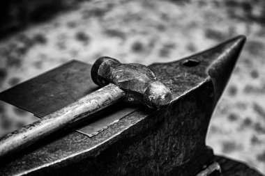 Old hammer and anvil on a forge, detail of old tool clipart