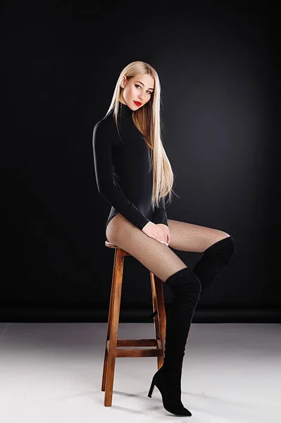 Loira Bodysuit Apertado Preto Botas Sentadas Uma Cadeira — Fotografia de Stock