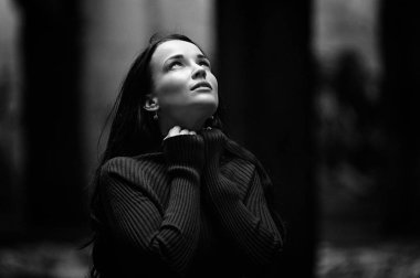 Bordo örgü süveterli bir esmer sonbahar ormanında yürüyor. Sonbaharda terk edilmiş bir binada esmer. Siyah beyaz portre