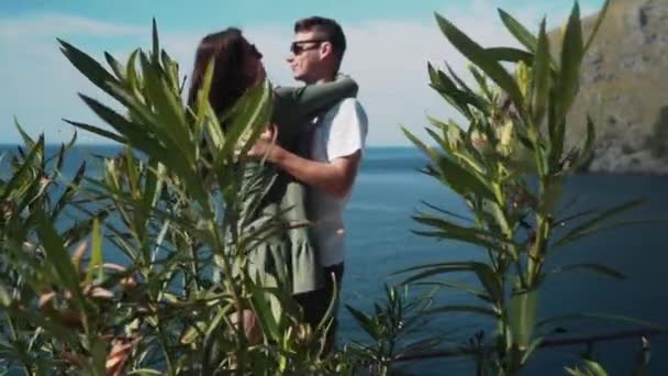 Couple kissing against sea and rocks in green plants. Sa Calobra — Stock Video