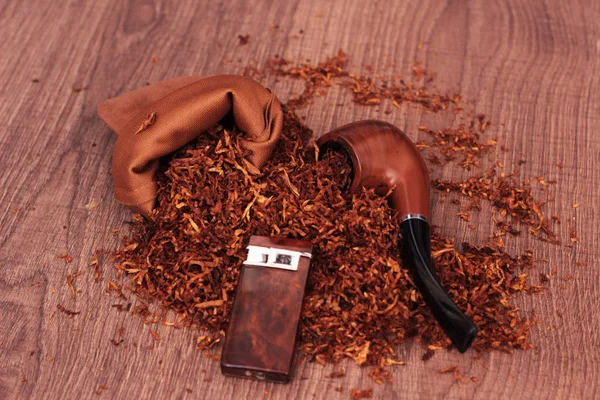 pile of tobacco smoking pipe and lighter