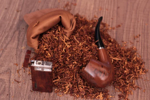 pile of tobacco smoking pipe and lighter