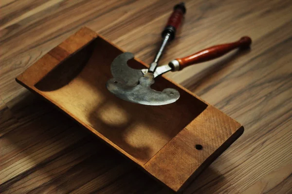 wooden trough and two hatchets