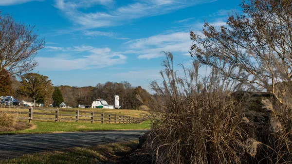 Farm buildings in Orange County North Carolina with fence in foreground