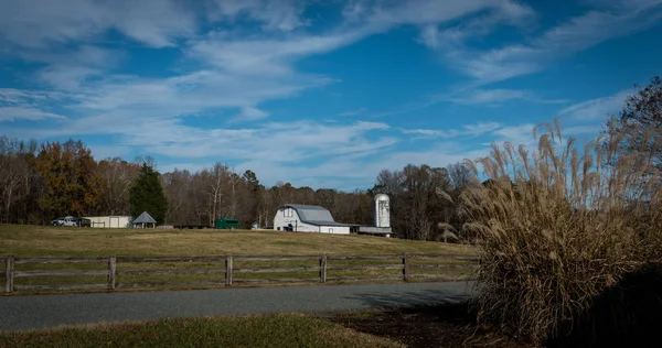 Farm buildings in Orange County North Carolina with fence in foreground